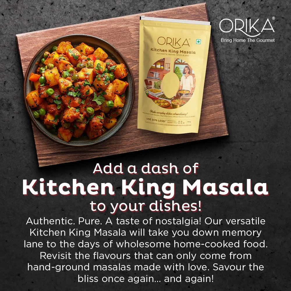 Orika Kitchen King Masala packet with a dish of food on a wooden board against a dark background.