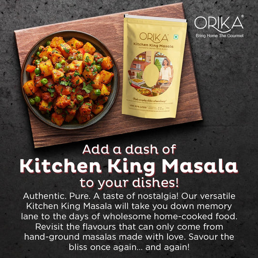 Orika Kitchen King Masala packet with a dish of food on a wooden board against a dark background.